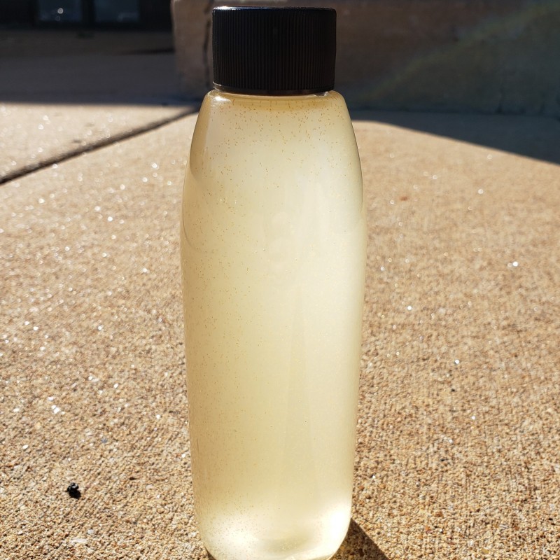 Bottle of cloudy liquid containing baby brine shrimp
